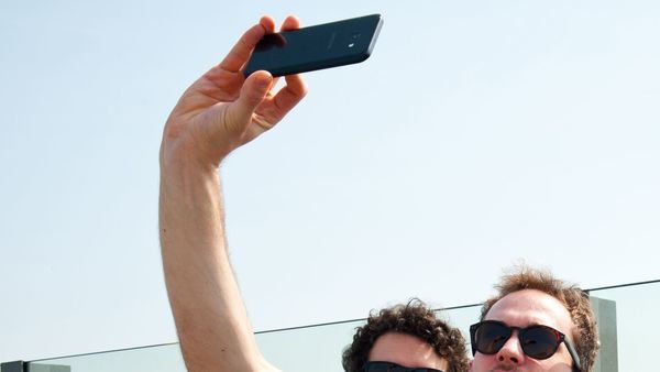 Friends take a selfie on the roof of the MAS