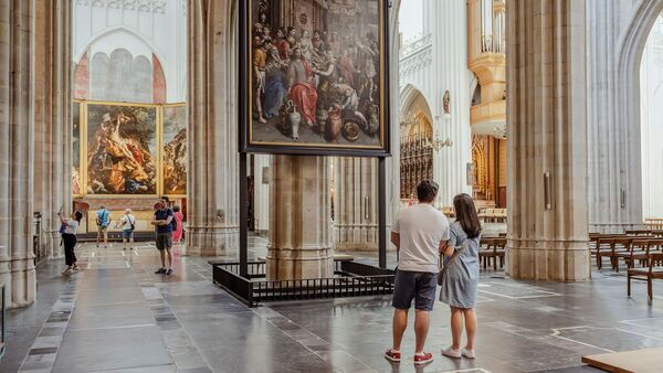Visitors pause at a work of art in the cathedral.
