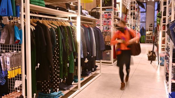 Vrouw bekijkt kledingrekken in Moose in the City