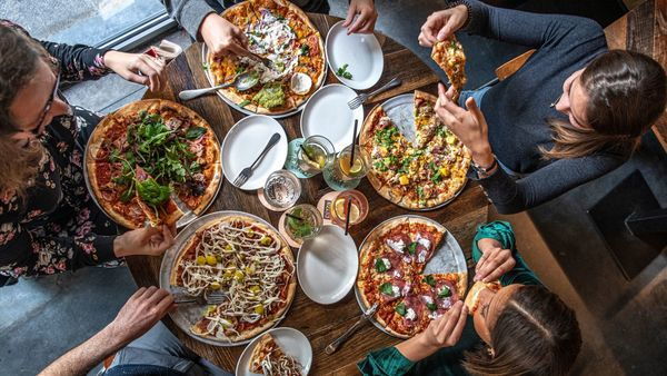 Girlfriends share pizzas at Otomat pizzeria