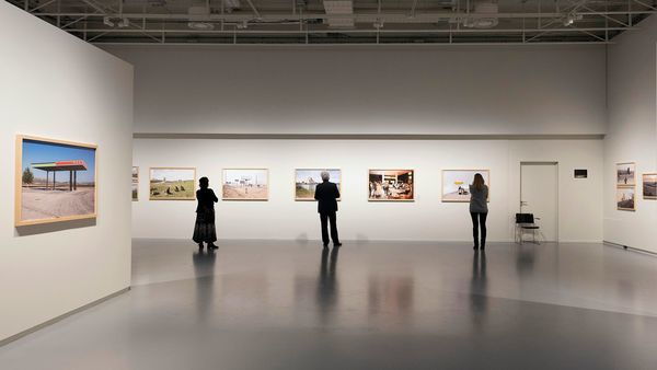 3 personnes regardent des photographies 