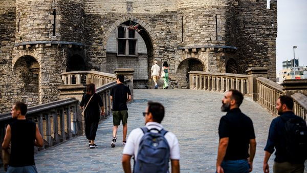 Visitors walk towards Het Steen