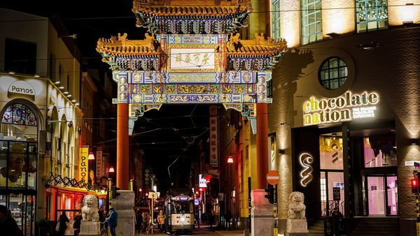 The pagoda gate in Chinatown by night. On the right, the entrance to Chocolate Nation.