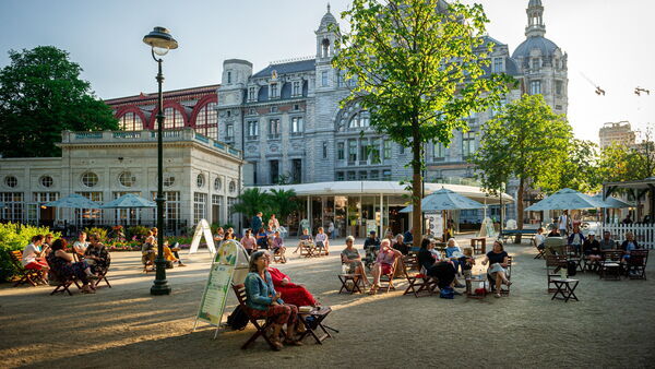 People are enjoying a drink with views on the Central Station and Zoo Antwerp.