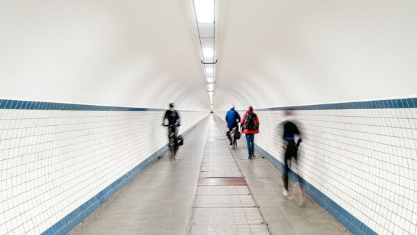 Walkers and cyclists in the pedestrian tunnel