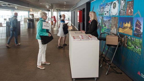 People request information from a cruise terminal employee.