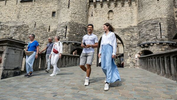 Couple is walking on the tallud of Het Steen