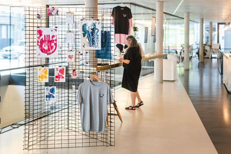 Exhibition featuring graphic designs and clothing at De Winkelhaak Design Centre in Antwerp.