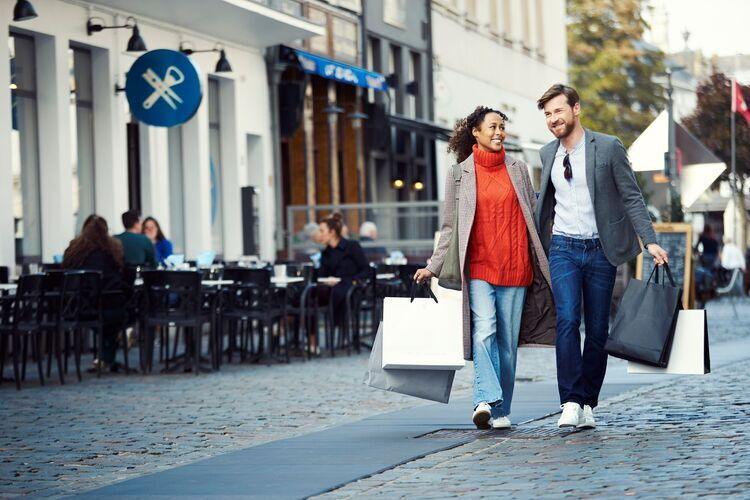 A couple carrying shopping bags