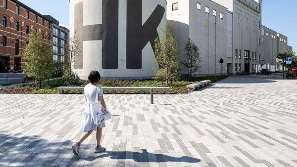 Eine Frau geht in Richtung des M HKA, Museum für zeitgenössische Kunst.
