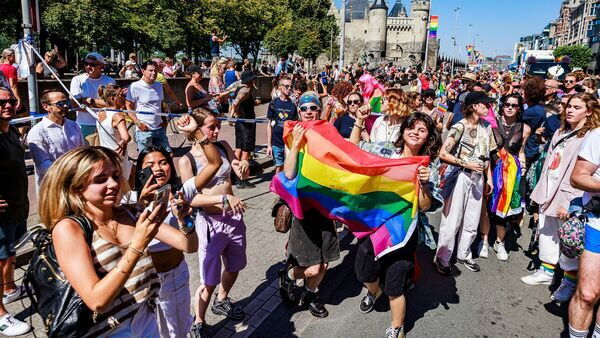 People waving a pride flag at Antwerp Pride 