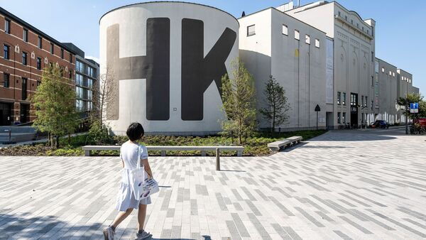 Lady walks towards the M HKA, museum of contemporary art.