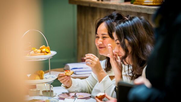 Two ladies enjoy sweet treats with their husbands at Salon de thé Claude