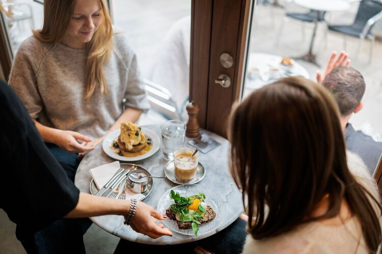 Two ladies are enjoying breakfast at Tinsel.