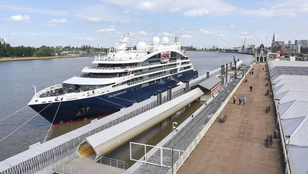 A cruise ship moored next to cruise terminal Het Steen.