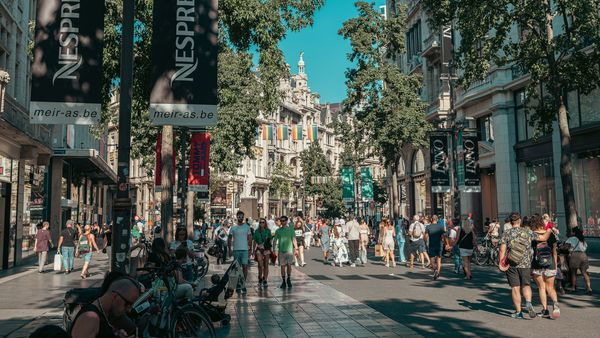 People stroll past shops along a wide, car-free boulevard: the Meir.