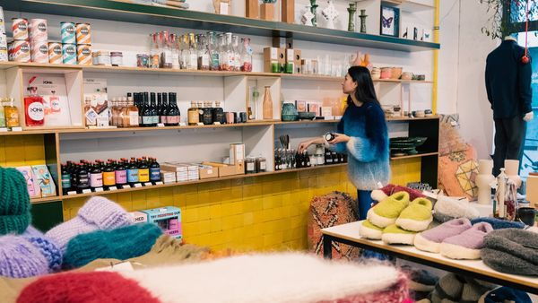 Girl looks at racks of food products and accessories from Curated by EDO