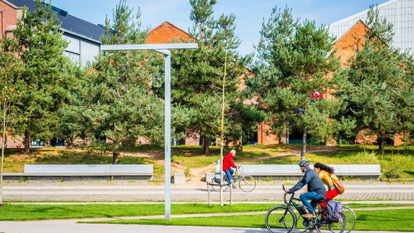 Three people cycle through Park Spoor Noord