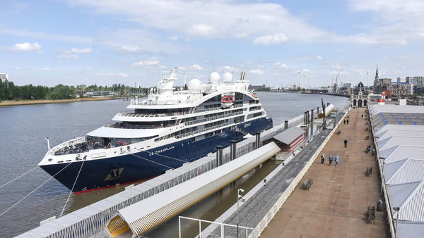 A cruise ship is moored next to the cruise terminal Het Steen